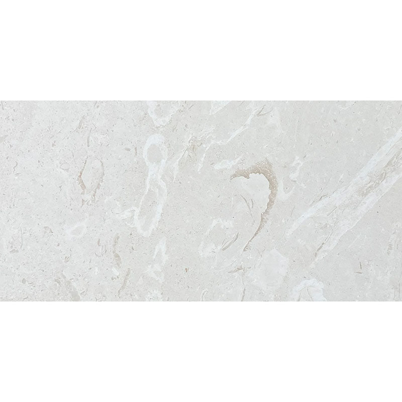 myra limestone honed tile in pure white with subtle shell fossil detail for bathroom floor and outdoor paver applications — Tile & Mosaic Depot