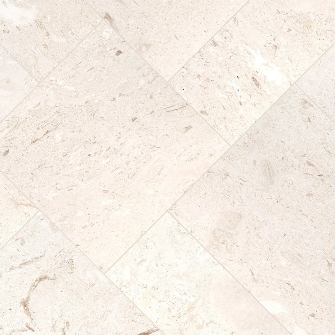 White Pearl Limestone pencil liner and bullnose molding trim in pure white with subtle fossil shell detail for bathroom and kitchen tile installations — Tile & Mosaic Depot