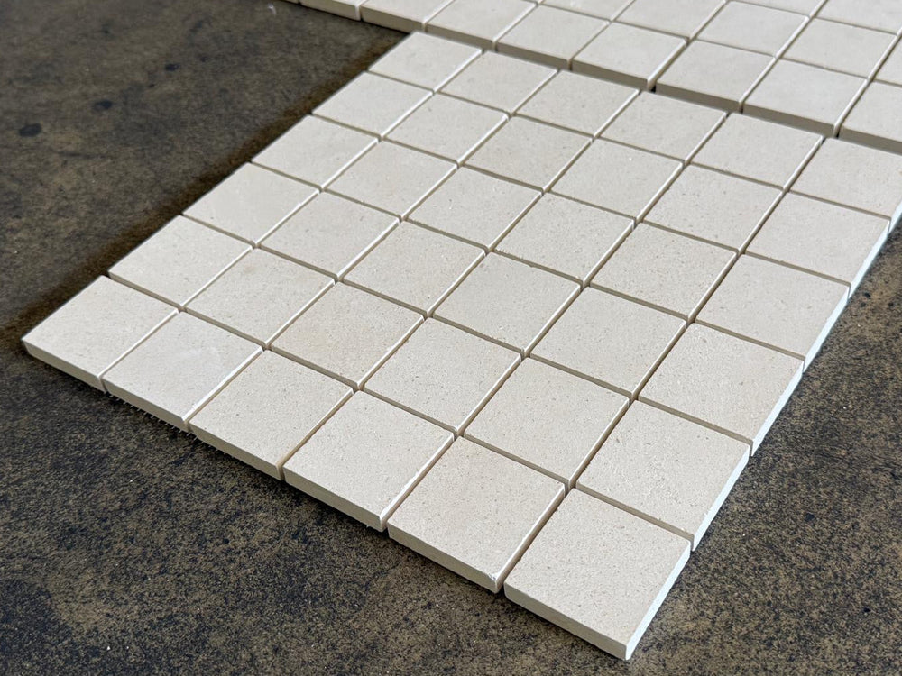 White Pearl Limestone mosaic tile with 2x2 honed marble squares, featuring a refined, textured surface for interior design.