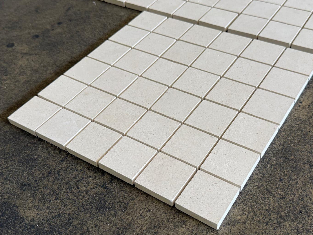 White Pearl Limestone mosaic tile with 2x2 honed marble squares, featuring a refined, textured surface for interior design.