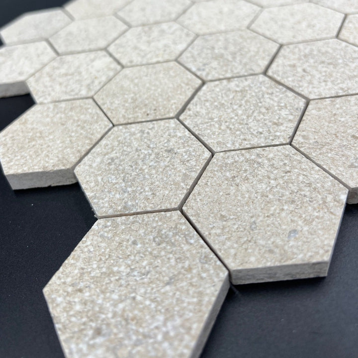 Mocha cream limestone antique Chanteau hexagon mosaic tile from TILE AND MOSAIC DEPOT, close-up of 2x2 decorative ceramic tile.