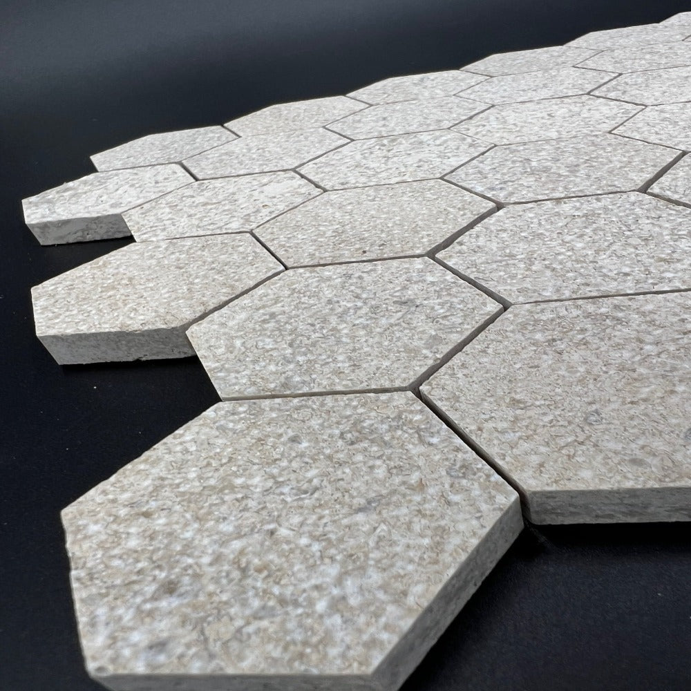 Mocha cream limestone antique Chanteau 2x2 hexagon mosaic tile by TILE AND MOSAIC DEPOT, showcasing textured, earthy stone pattern.
