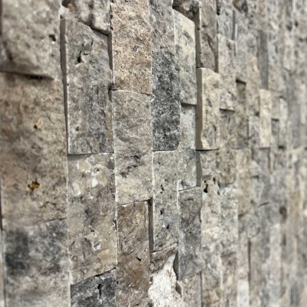 Close-up of silver split face 1x2 wall with rectangular stone tiles.