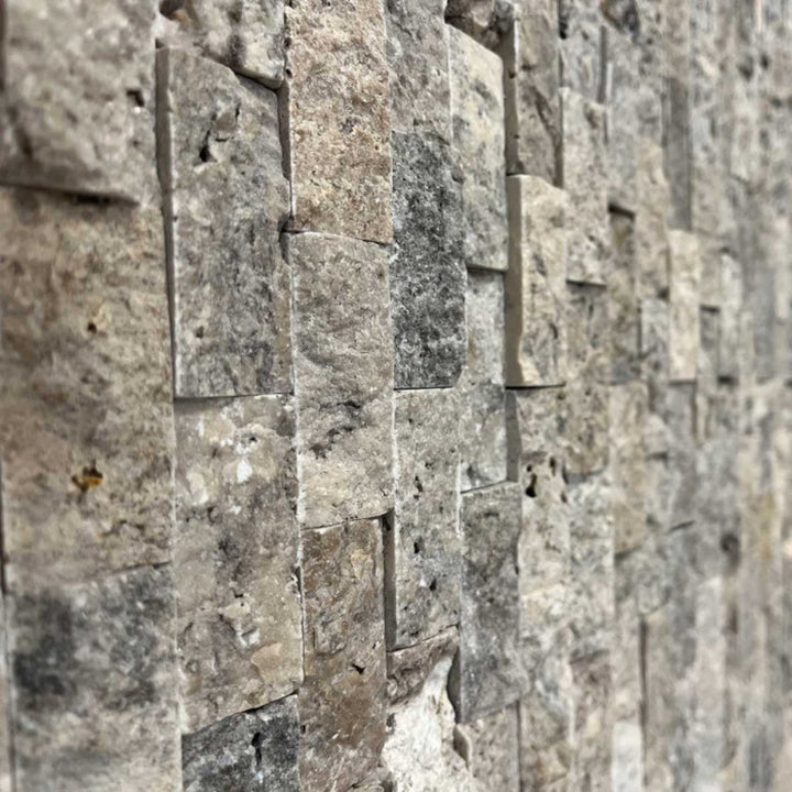 Close-up of silver split face 1x2 wall with rectangular stone tiles.