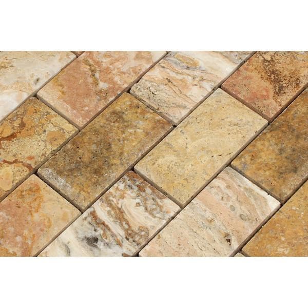 Two 4-inch honed Scabos travertine deep-beveled brick mosaic tiles with natural earthy tones and textured surface.