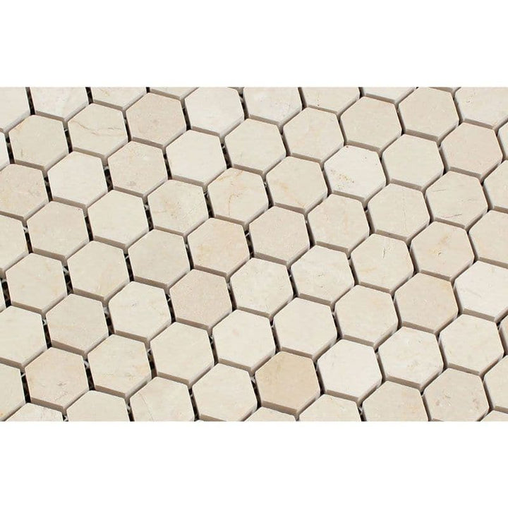 Crema Marfil marble 1x1 hexagon polished mosaic tile showing beige and cream tones with a smooth surface.