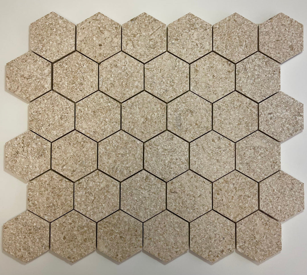 Gascogne Beige 2x2 hexagon tumbled limestone mosaic tile showing beige natural stone with textured surface and grid pattern.
