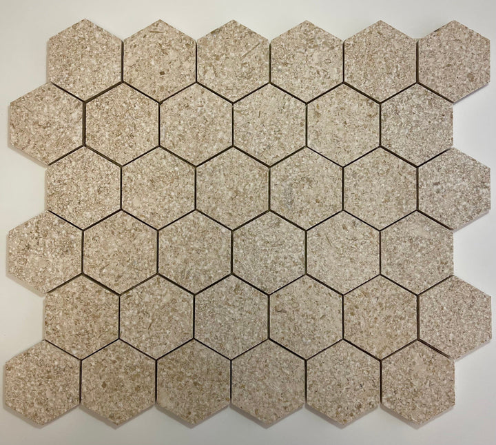 Gascogne Beige 2x2 hexagon tumbled limestone mosaic tile showing beige natural stone with textured surface and grid pattern.