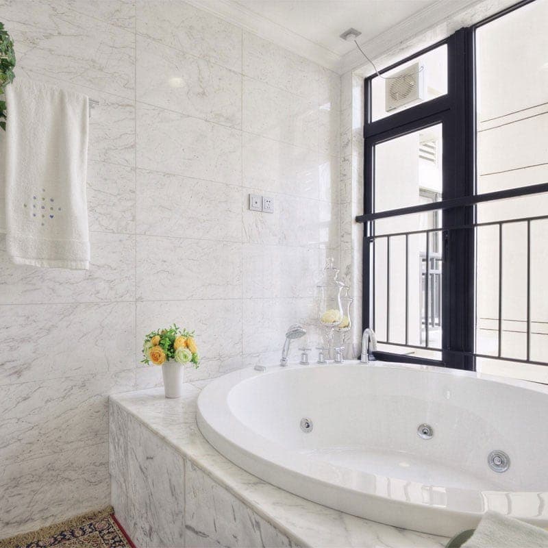 White Carrara marble 12x24 polished natural stone tile with gray veining, ideal for elegant flooring or backsplash designs.
